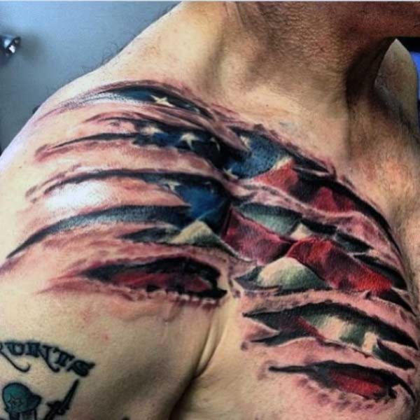 American Flag Ripping Skin Tattoo On Front Shoulder