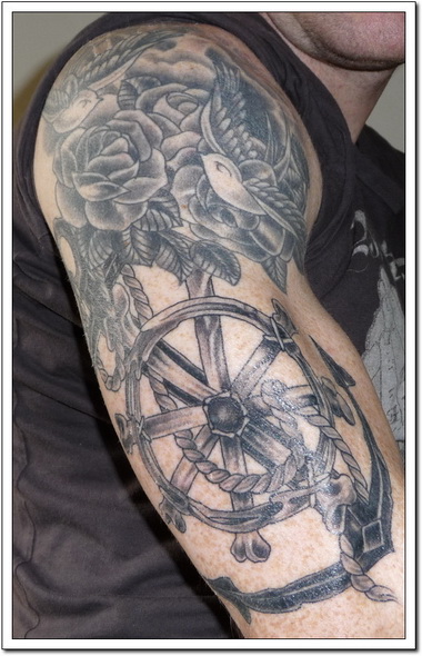 Black Wheel And Flower Viking Tattoo
