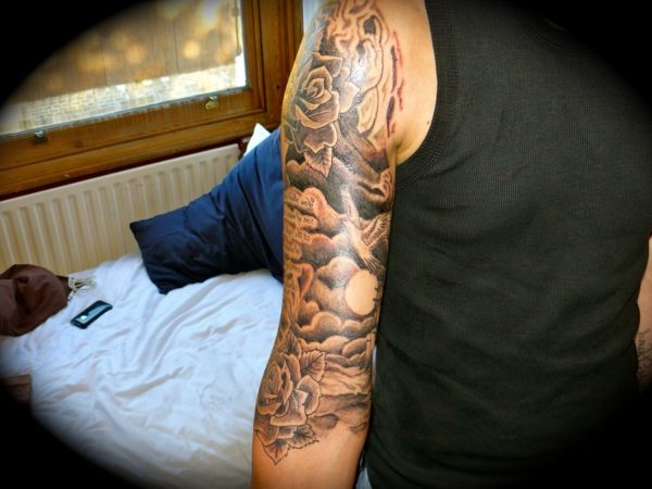 Nice Flowers In Cloud Tattoo On Shoulder