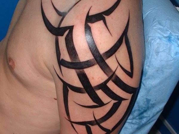 Tribal Shining Tattoo On Left Shoulder